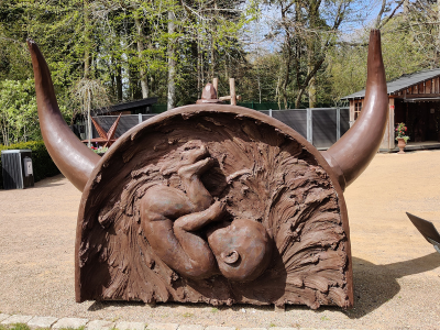 ConcreteClay sculpture of a baby within a giant viking helmet