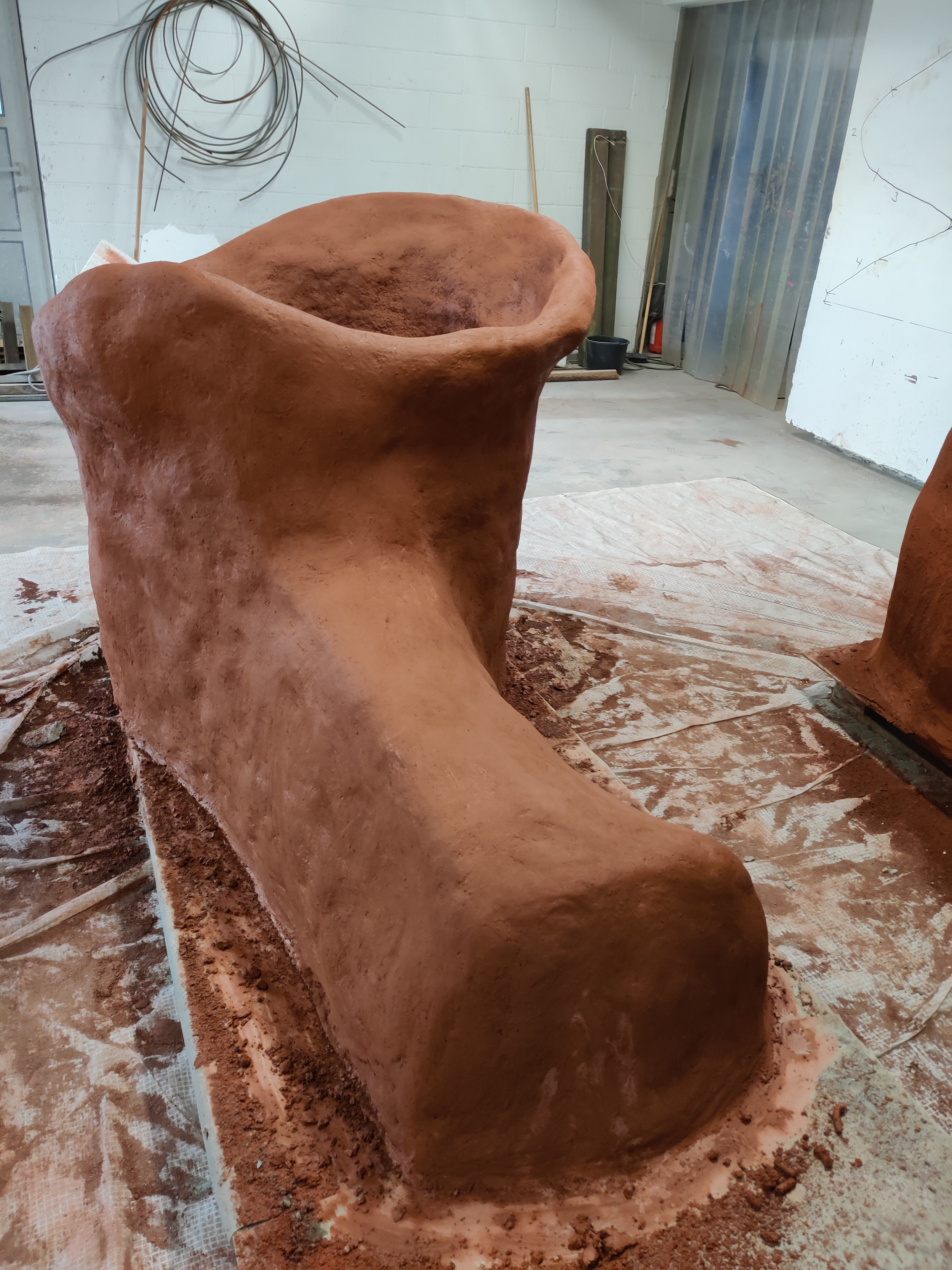 Big ConcreteClay jar that resembles a shoe