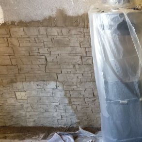 Livingroom getting a stonewall made with ConcreteClay.